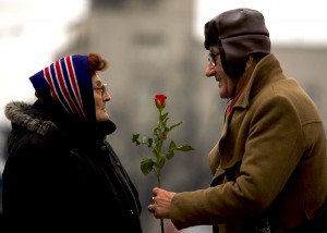 A man offers a rose to a woman to mark International Women's Day in Belgrade